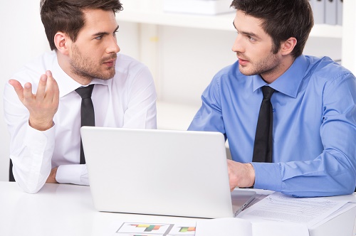 two businessmen having discussion in office.